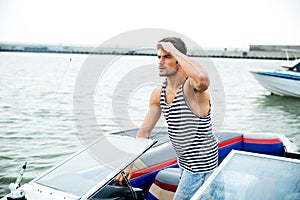 Young handsome man preparing boat to start a journey