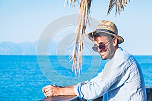 Young handsome man relaxing at the beach bar