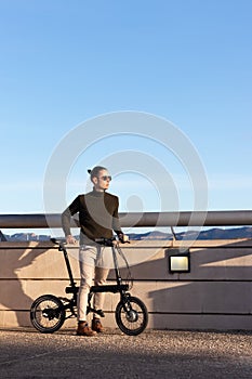 Young handsome man riding an electric bicycle as a sustainable and eco friendly alternative to go around the city