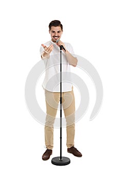 Young handsome man singing in microphone