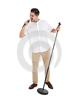 Young handsome man singing in microphone