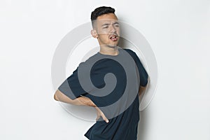 Young handsome man suffering low back pain and waist lumbar pain on white background