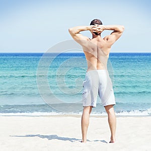 Young and handsome man on a summer beach