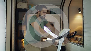 A young handsome man trains on a stationary bike