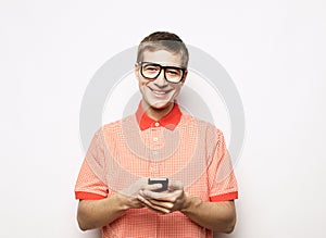 young handsome man typing sms on white background