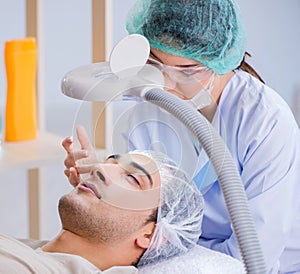 Young handsome man visiting female doctor cosmetologist