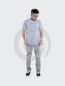 Young handsome man was posing wearing heather grey t-shirt short sleeve with mockup concept