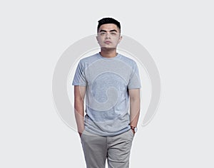 Young handsome man was posing wearing heather grey t-shirt short sleeve with mockup concept