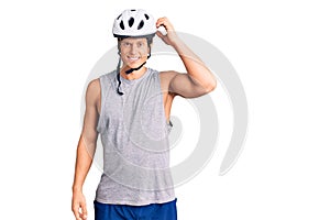 Young handsome man wearing bike helmet confuse and wonder about question