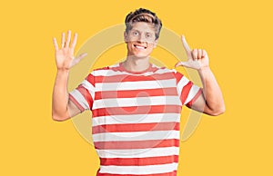 Young handsome man wearing casual clothes showing and pointing up with fingers number seven while smiling confident and happy