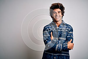 Young handsome man wearing casual shirt standing over isolated white background happy face smiling with crossed arms looking at