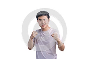 Young handsome man wearing casual t-shirt over white background. Punching fist to fight, aggressive and angry attack, threat and