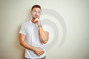 Young handsome man wearing casual white t-shirt over isolated background Thinking worried about a question, concerned and nervous