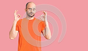 Young handsome man wering casual t shirt relax and smiling with eyes closed doing meditation gesture with fingers