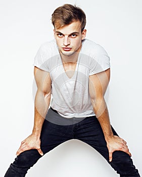 Young handsome man on white background gesturing, pointing, posing emotional, cute guy