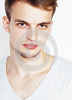 Young handsome man on white background gesturing, pointing, posing emotional, cute guy