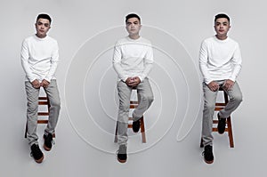 Young handsome men wearing white long sleeve t-shirt was sitting and posing in a chair with plain background