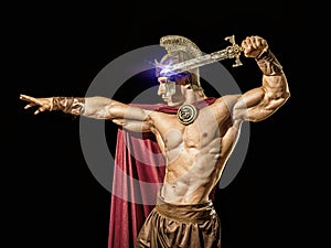 Young muscular man posing in roman gladiator costume