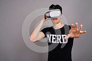 Young handsome nerd man wearing virtual reality headset