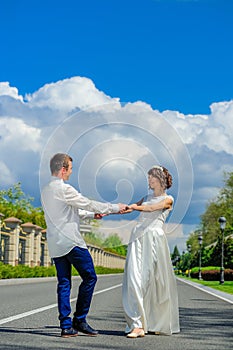 Young and handsome newlyweds on a walk in the park