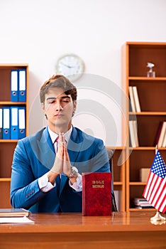 The young handsome politician sitting in office