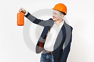 Young handsome smiling businessman in dark suit, protective construction helmet holding case with instruments or toolbox