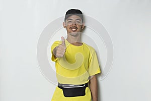Young handsome sport man showing a thumbs up ok gesture on white background