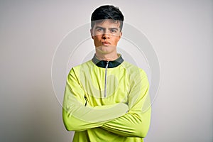 Young handsome sportsman doing sport wearing sportswear over isolated white background skeptic and nervous, disapproving