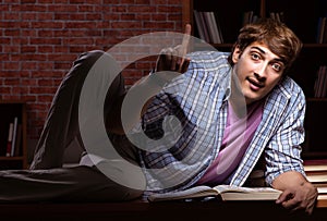 Young handsome student preparing for exams at night