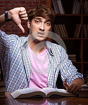 Young handsome student preparing for exams at night