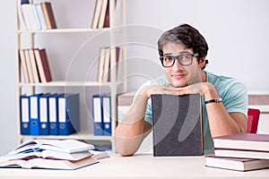 The young handsome student preparing for school exams