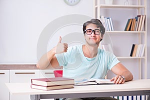 The young handsome student preparing for school exams