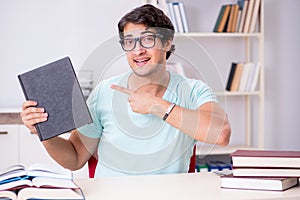 The young handsome student preparing for school exams