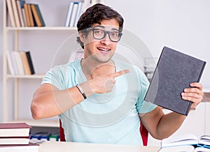 Young handsome student preparing for school exams