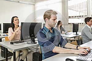 Young handsome student using computer