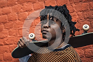 Young handsome stylish black man with natural hair dreadlocks. Afroamerican guy.Stairs,wall painted with graffiti in