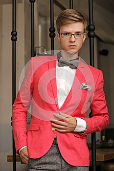 Young handsome stylish man posing indoor