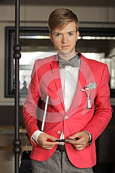 Young handsome stylish man posing indoor