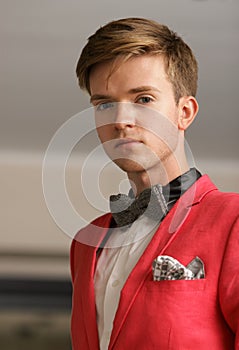 Young handsome stylish man posing indoor