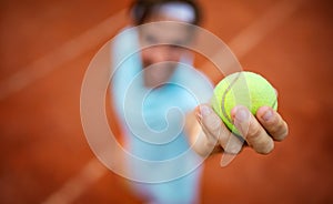 Young handsome tennis player with racket and ball prepares to serve at beginning of game or match.