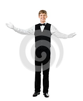 Young handsome waiter gesturing welcome