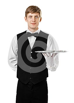 Young handsome waiter holding empty tray