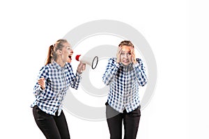 Young handsome woman arguing with herself on white studio background.
