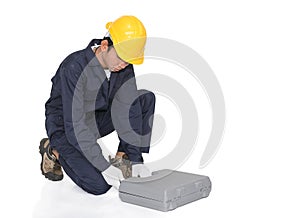 Young handyman sitting with his tool box