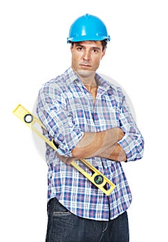 Young handyman with a spirit level against white background. Portrait of young handyman with a spirit level in hand