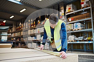 Young handyman working in a warehouse