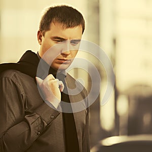 Young hansome business man walking on city street