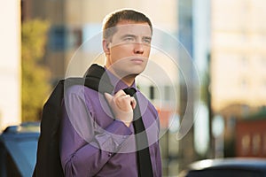 Young hansome business man walking on city street