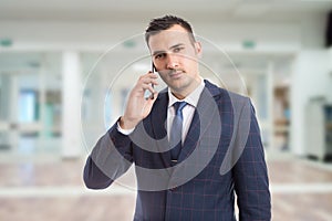 Young hansome realtor using smartphone