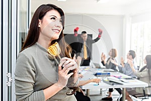 Young happiness confident asian businesswoman and team winning a gold trophy in the office. Successful business team rewarded .